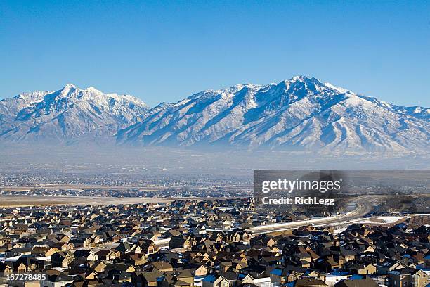 neighborhood under snow-capped mountains - utah house stock pictures, royalty-free photos & images