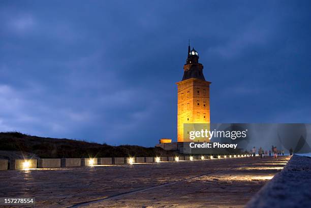 landscape of hercules tower illuminated at dusk - a coruna stock pictures, royalty-free photos & images