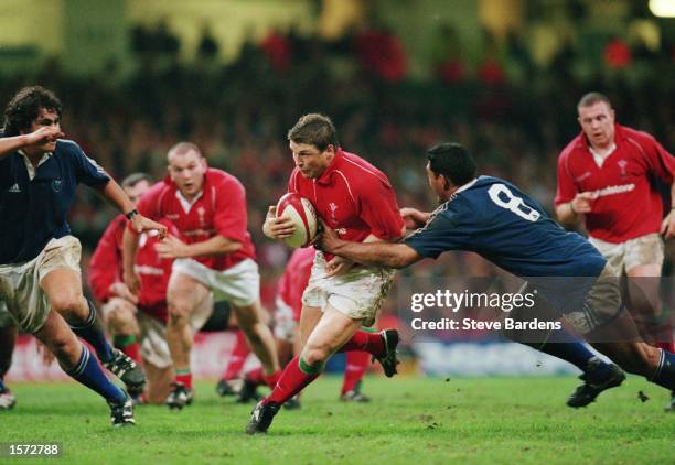 Scott Gibbs of Wales looks to go past Junior Maligi of Samoa during the Rugby Union International Friendly match played at the Millennium Stadium, in...