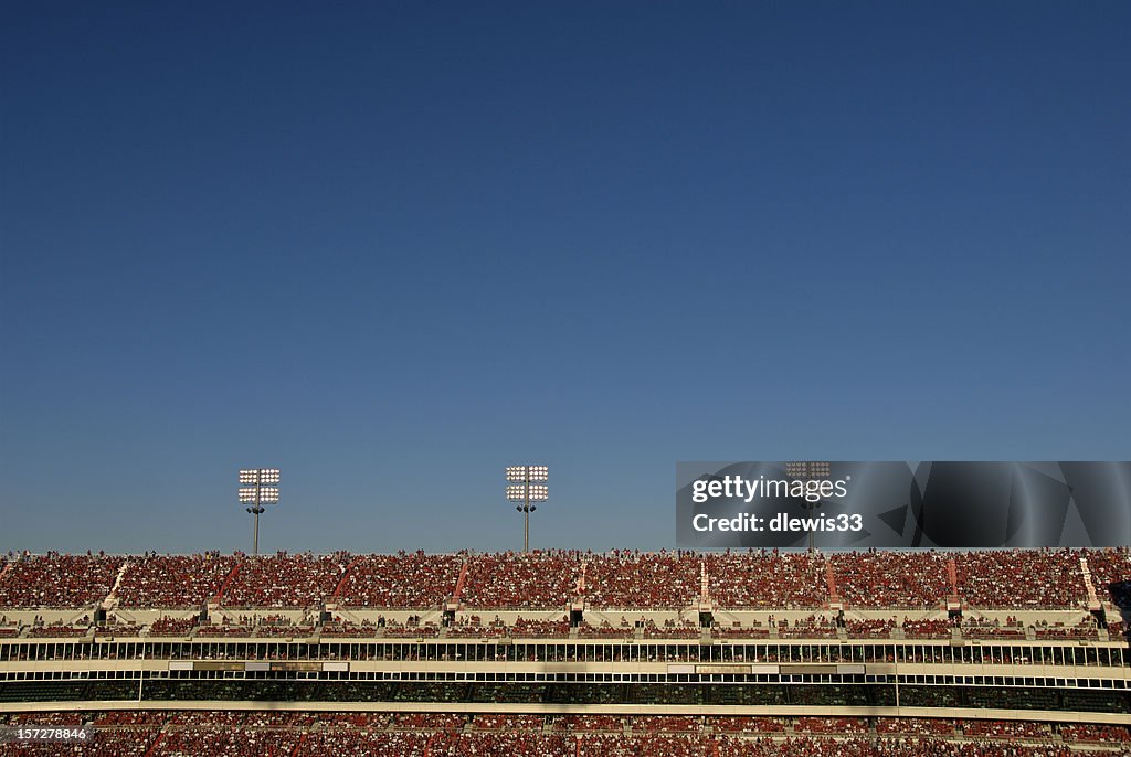 Stadium Crowd Under Blue Sky