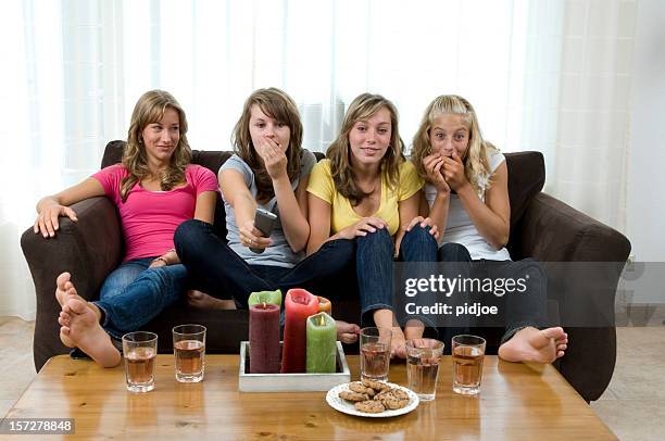 teenage girls watching tv show - jeans barefoot girl stock pictures, royalty-free photos & images