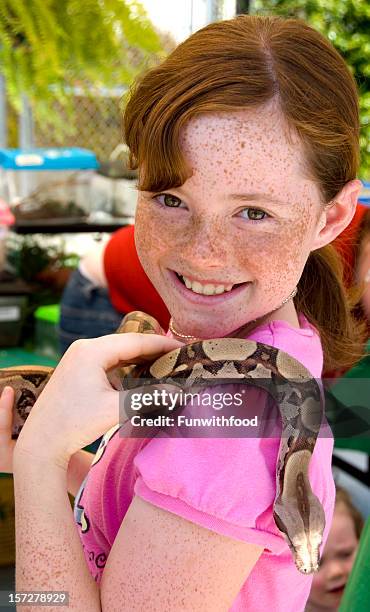 fearless redhead freckle face girl & reptile, adventurous child holding snake - freckle arm stock pictures, royalty-free photos & images