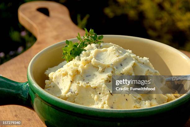 a green bowl of herbed mashed potatoes - mashed potatoes stock pictures, royalty-free photos & images