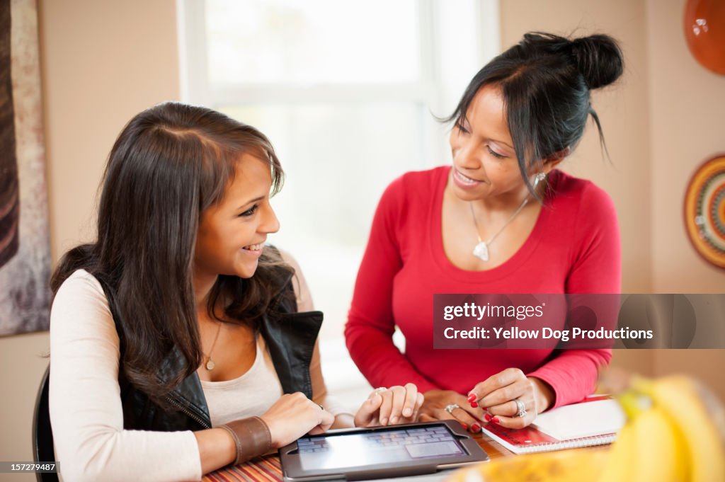 Mom and Daughter smiling at each other at home