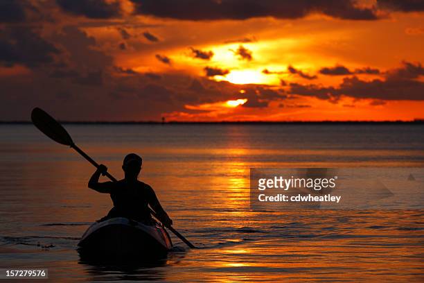 woman kayaking during sunset in florida keys - gulf coast states stock pictures, royalty-free photos & images
