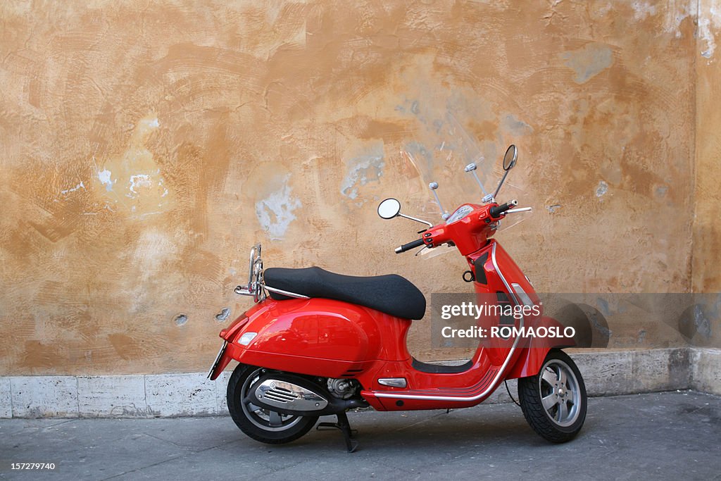 Red scooter and Roman wall, Rome Italy
