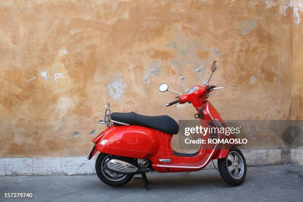 red scooter and roman wall, rome italy - red motorcycle stock pictures, royalty-free photos & images