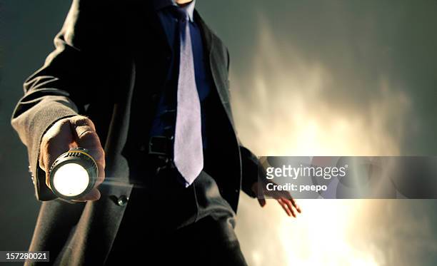 man in suit holding torch - detective stock pictures, royalty-free photos & images