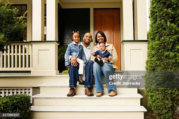 happy family on front porch - family smiling at front door stock pictures, royalty-free photos & images