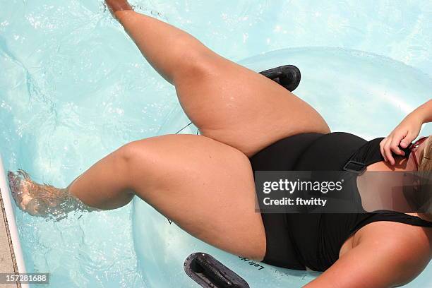 innertubing - fat legs stock pictures, royalty-free photos & images