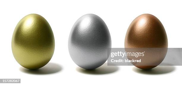 gold silver and bronze eggs on white background - golden egg stock pictures, royalty-free photos & images