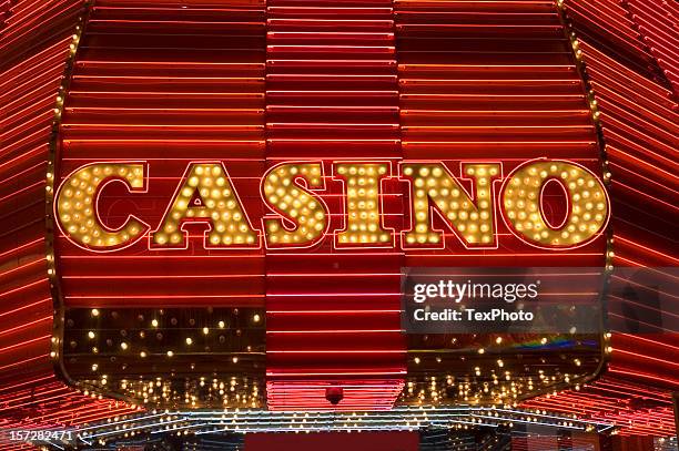 bright yellow las vegas neon lights spelling casino - las vegas sign stockfoto's en -beelden