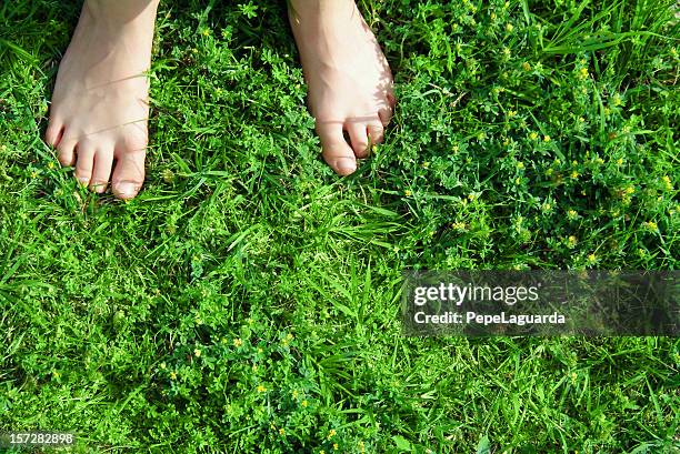 barefooted on the grass (real emotions) - barefoot child stock pictures, royalty-free photos & images