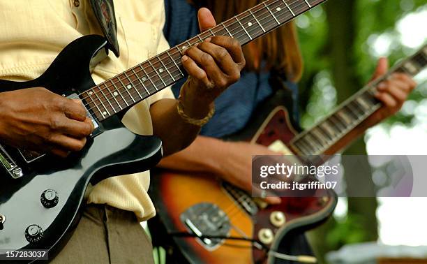 close up of two people playing guitars - chicago musical stockfoto's en -beelden