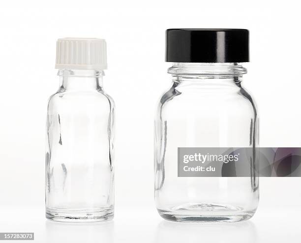 two empty capsule bottles - glas bottle stock pictures, royalty-free photos & images