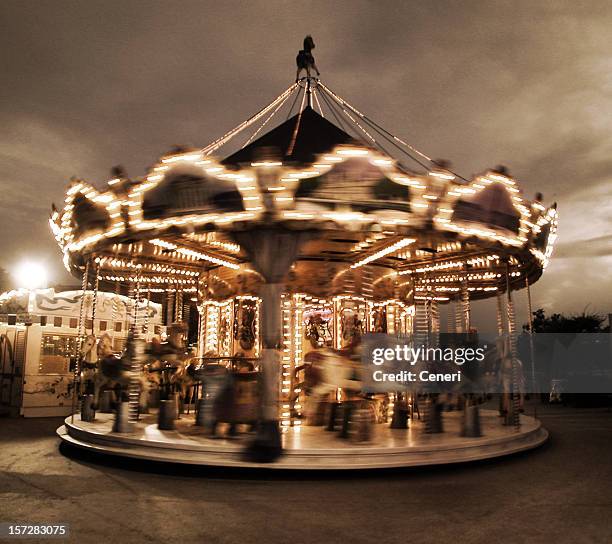 spinning carousel in paris - carousel horse stock pictures, royalty-free photos & images