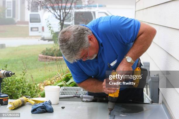 ac repair 9 showing a man drilling a table with a drill - air conditioner technician stock pictures, royalty-free photos & images