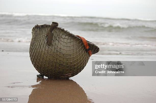 beach landing. - army helmet stockfoto's en -beelden