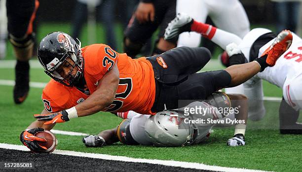 Running back Malcolm Agnew of the Oregon State Beavers dives into the endzone for a touchdown in the fourth quarter of the game against the Nicholls...