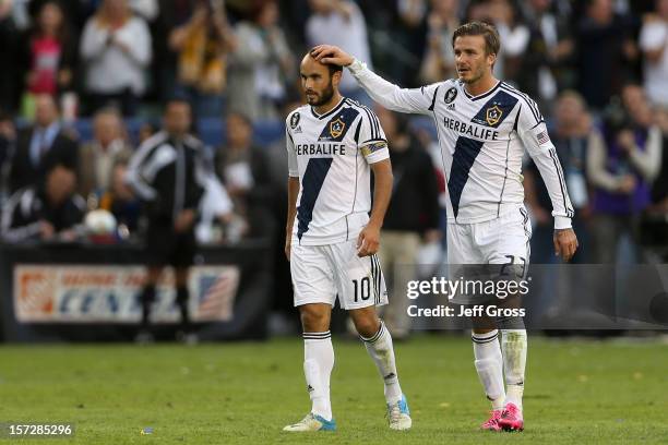 Landon Donovan and David Beckham of Los Angeles Galaxy celebrate in the second half against the Houston Dynamo in the 2012 MLS Cup at The Home Depot...