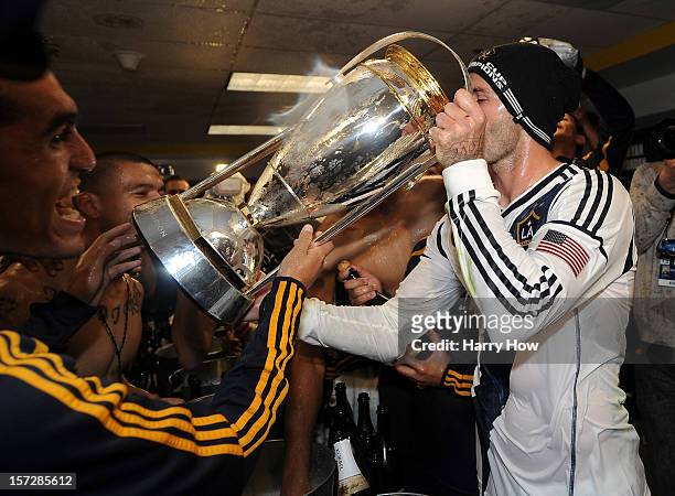 David Beckham of Los Angeles Galaxy drinks out of the MLS Trophy after the Galaxy defeat the Houston Dynamo 3-1 to win the 2012 MLS Cup at The Home...