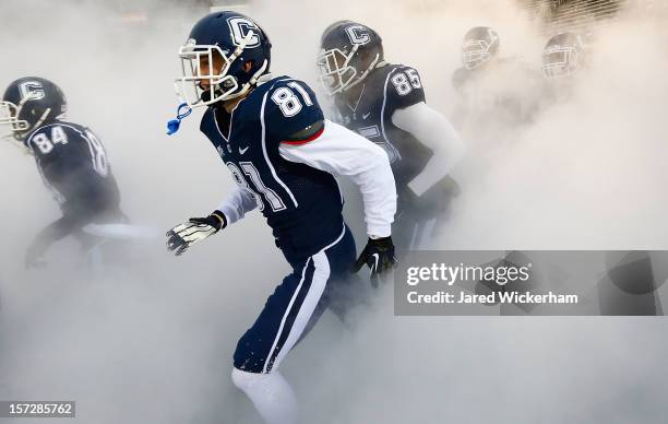 Michael Matson of the Connecticut Huskies runs onto the field with his teammates prior to the game against the Cincinnati Bearcats during the game at...