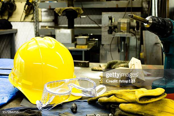 tools, gloves, hardhat and goggles are on the bench. - eye protection stock pictures, royalty-free photos & images