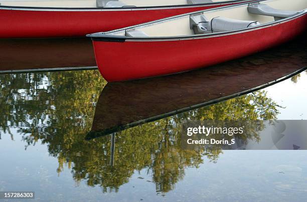 canoes on calm lake - north cove stock pictures, royalty-free photos & images