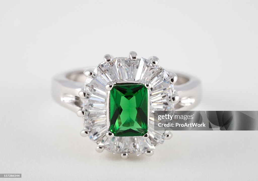 Emerald diamond ring on white background