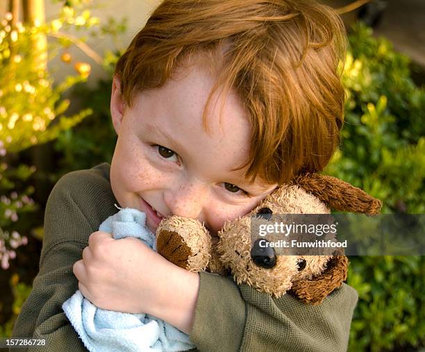 boy toddler hugging dog stuffed animal, child consoling with blanket - stuffed toy stock pictures, royalty-free photos & images