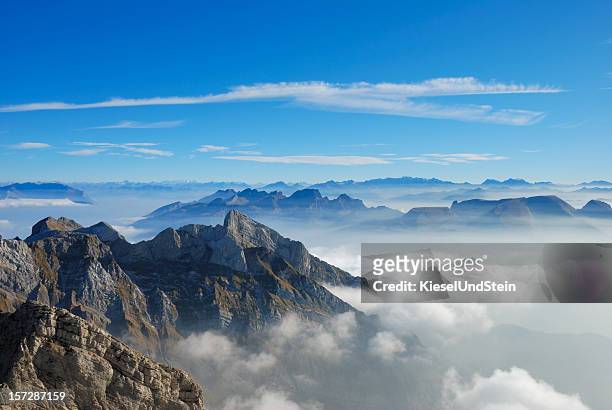 picture of a mountain top from above the clouds - mountain peak above clouds stock pictures, royalty-free photos & images
