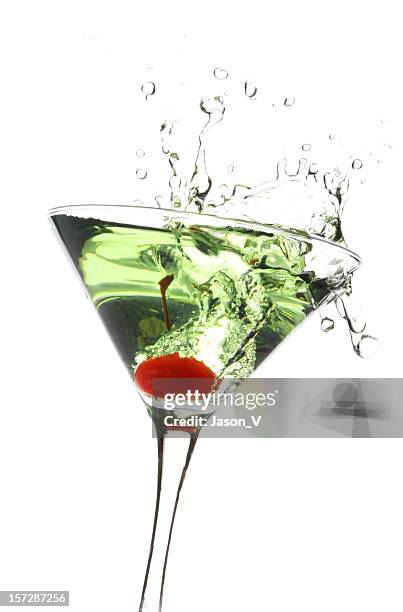 cherry being dropped in a green apple martini - splashing cocktail stock pictures, royalty-free photos & images