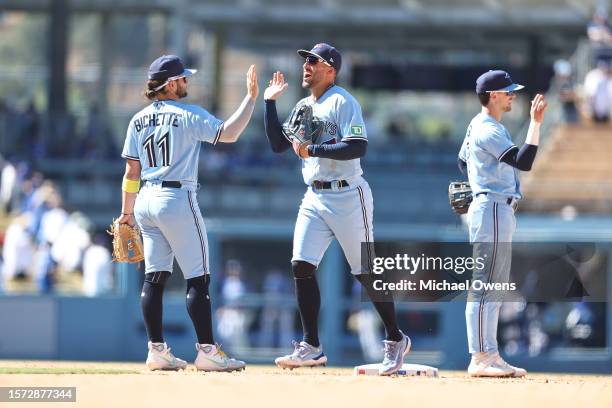 George Springer of the Toronto Blue Jays celebrates with his teammate Bo Bichette after defeating the Los Angeles Dodgers, 8-1, during the ninth...