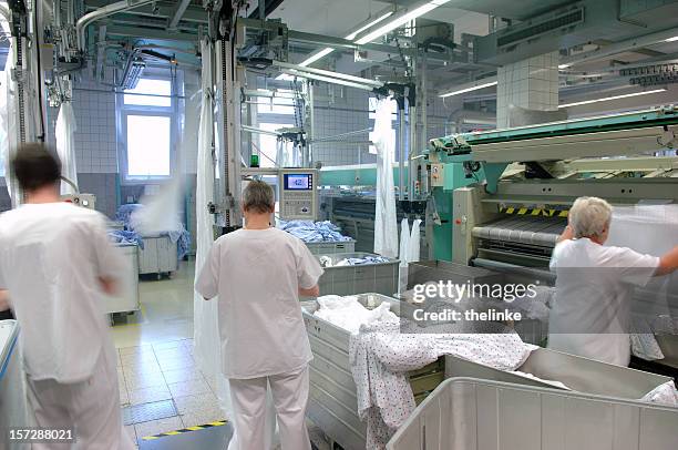 industrial workers processing laundry - clothes wringer stock pictures, royalty-free photos & images