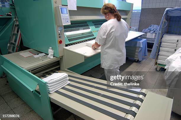 woman working at a mangle - clothes wringer stock pictures, royalty-free photos & images