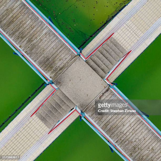 aerial view intersecting walkways over green salt ponds, oberndorf am neckar, germany - square stock pictures, royalty-free photos & images