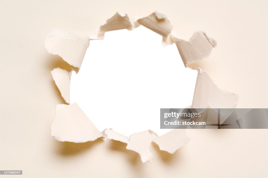 Ripped hole in a paper, isolated