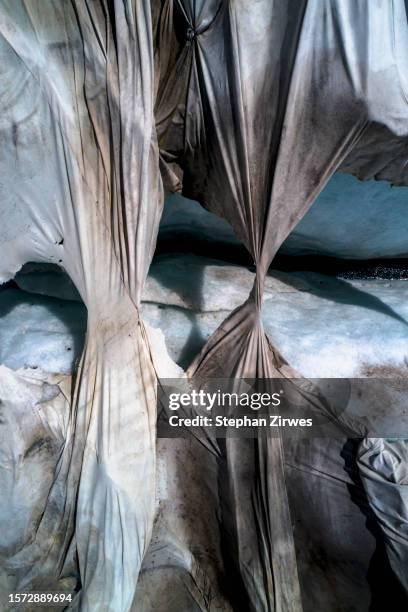aerial view ripped protective tarpaulin over rhone glacier, switzerland - extremlandschaft stock-fotos und bilder