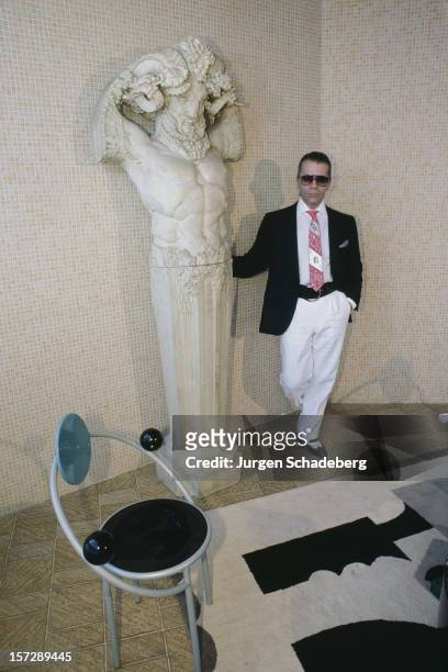 German fashion designer Karl Lagerfeld poses with a piece of sculpture, 1984.
