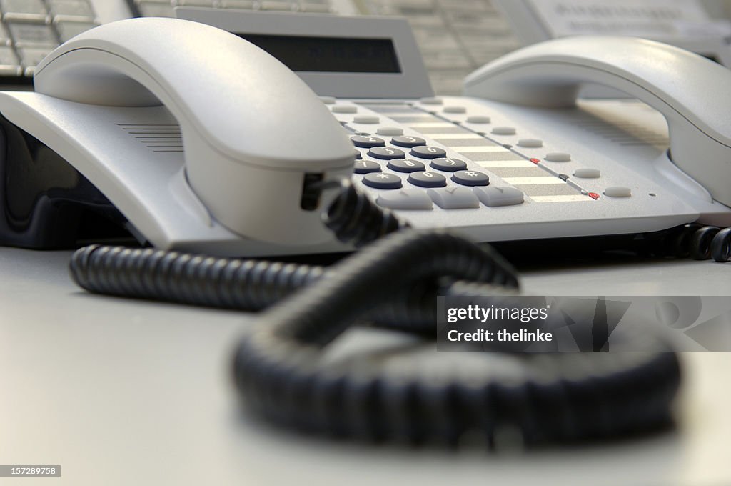 Close up of white landline phone on desk