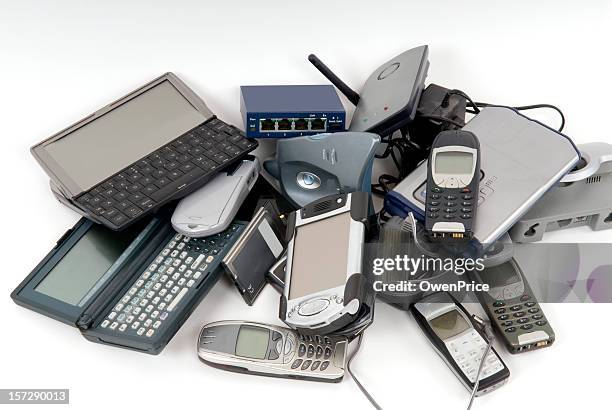 pile of discarded computers and phones - electrical equipment stock pictures, royalty-free photos & images