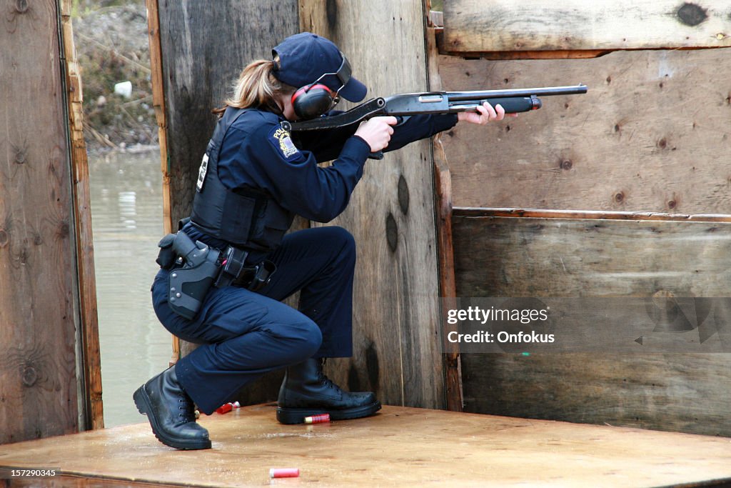 Woman Police Officer Shooting Shotgun at the Practice Field