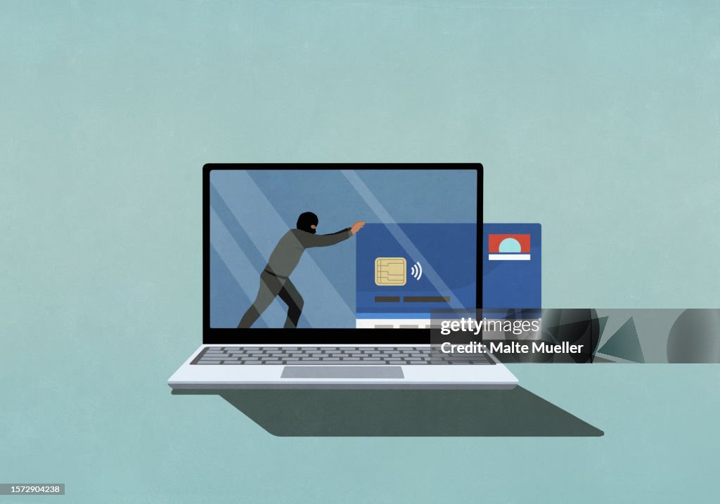 Computer hacker pushing credit card off laptop screen