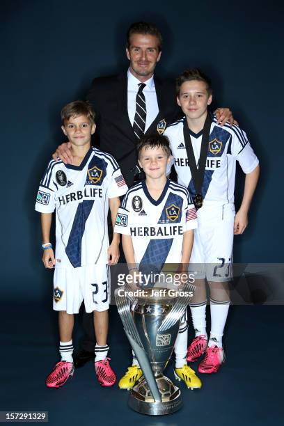David Beckham of the Los Angeles Galaxy poses with his sons, left to right, Romeo, Cruz and Brooklyn after the Los Angeles Galaxy won the 2012 MLS...
