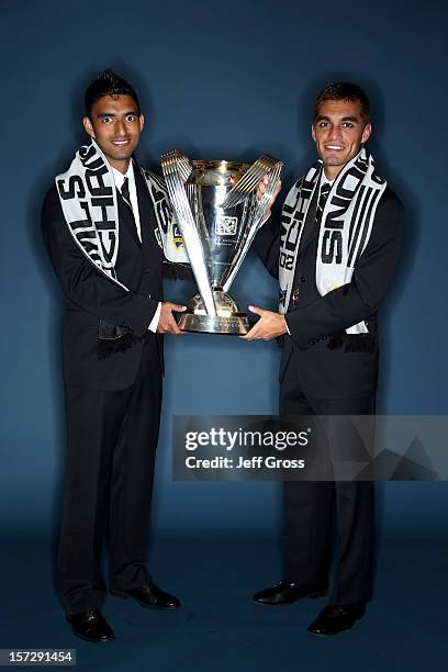 DeLaGarza and Hector Jimenez of the Los Angeles Galaxy pose after winning the 2012 MLS Cup 3-1 against the Houston Dynamo at The Home Depot Center on...
