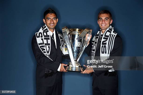 DeLaGarza and Hector Jimenez of the Los Angeles Galaxy pose after winning the 2012 MLS Cup 3-1 against the Houston Dynamo at The Home Depot Center on...