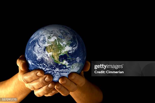 man with planet earth in hands - exists stock pictures, royalty-free photos & images