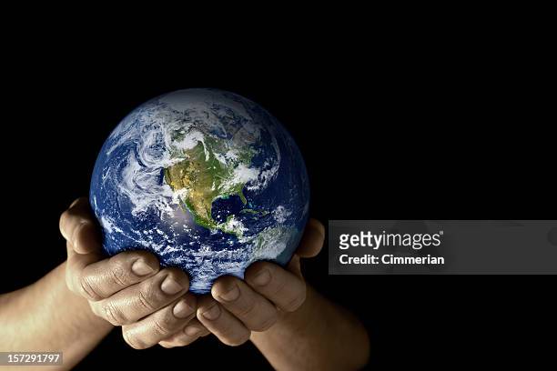 earth in my hands (tint) - international politics stock pictures, royalty-free photos & images
