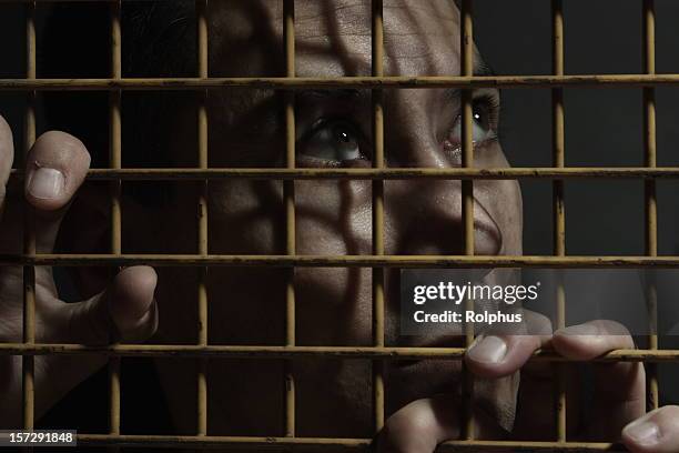 desperate in jail - left eye stock pictures, royalty-free photos & images