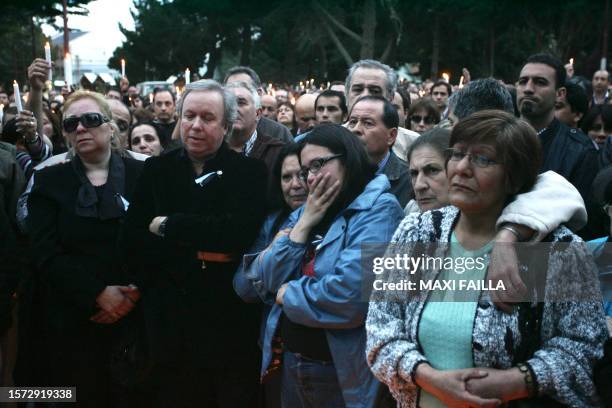 People gesture in front of the chapel where a funeral mass for former Argentine President Nestor Kirchner is being held on October 27, 2010 in the...